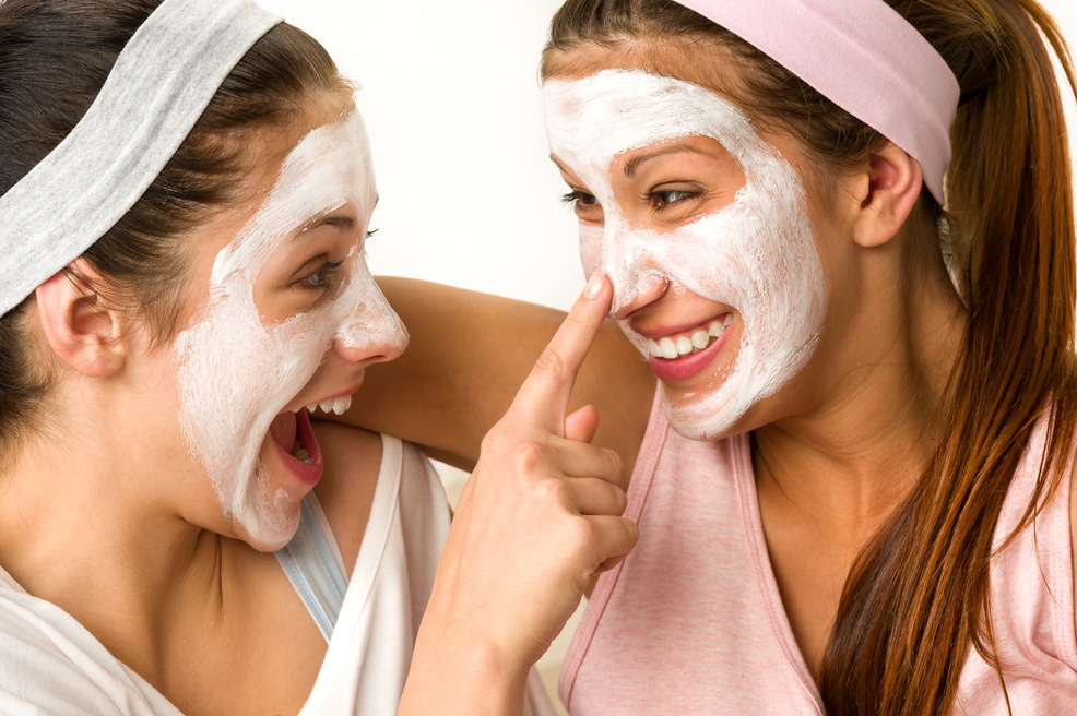 Playful Teen Wearing Mask Touches Friend's Nose